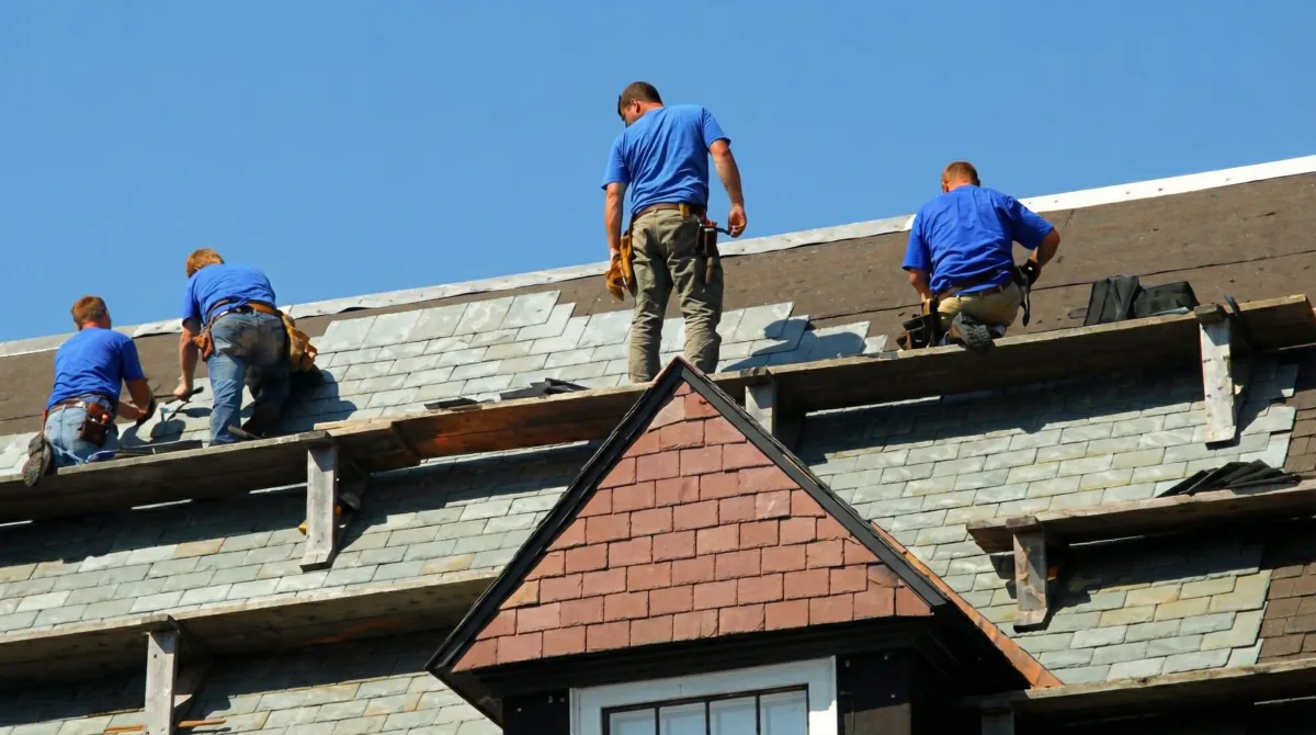 Roof replacement in progress with a team of professional contractors installing new shingles on a residential home in Lakeland, FL